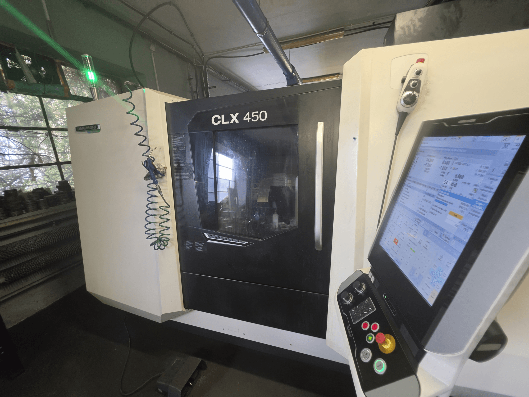 DMG MORI CLX 450 V3 horizontalus tekinimo staklės, vaizdas iš priekio su valdymo pultu ir monitoriumi, kuriame rodomi darbo duomenys.