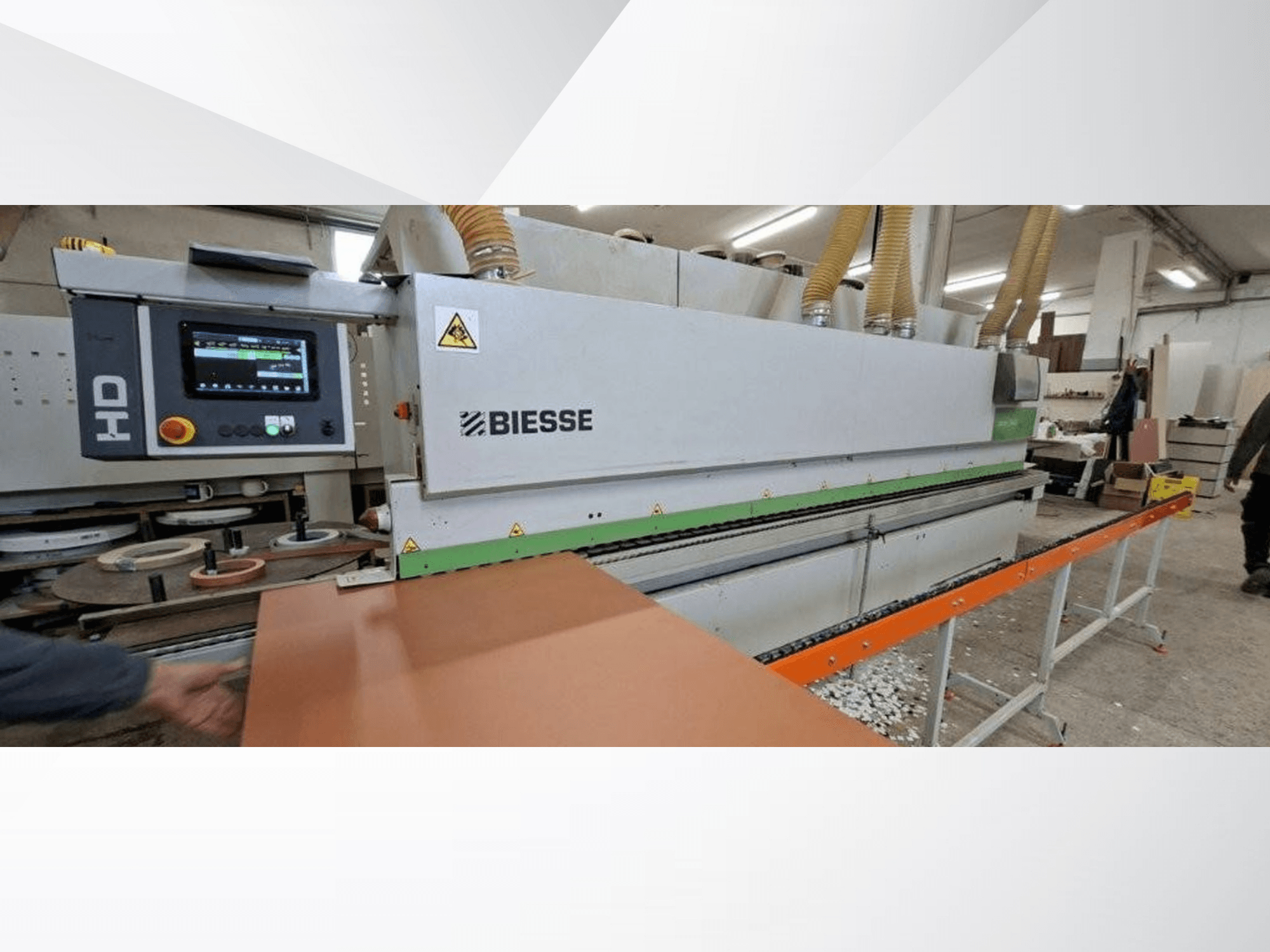 „BIESSE JADE 340“ kraštų apdirbimo staklės dirbtuvėse, vaizdas iš priekio su skaitmeniniu valdymo pultu ir oranžiniu padavimo stalu.