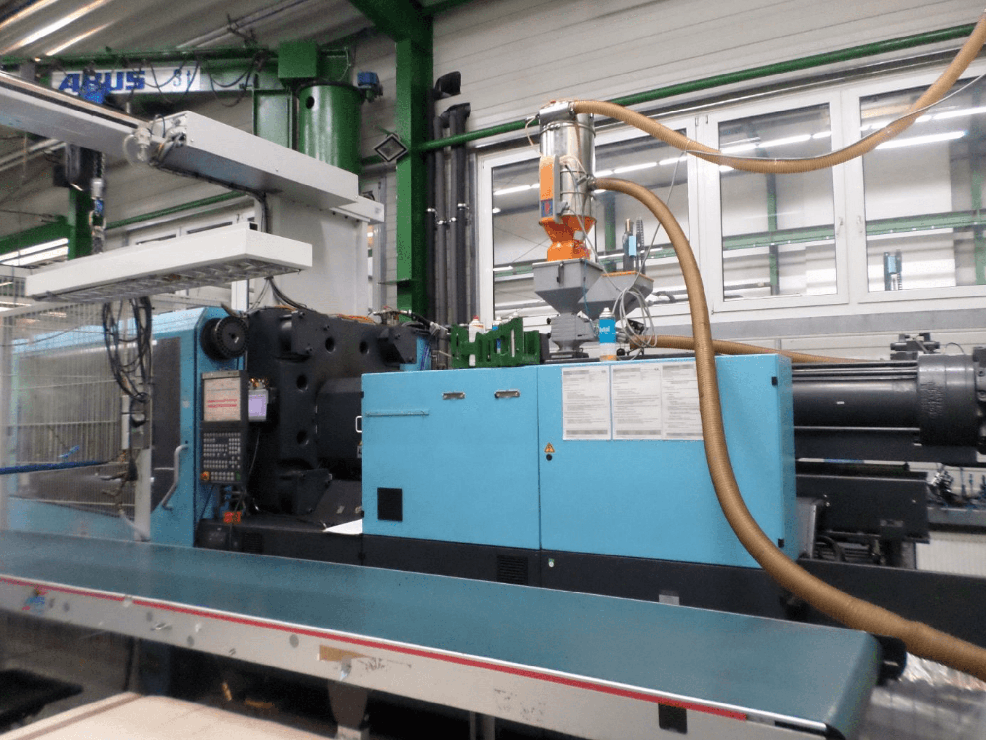 DEMAG D 420 hidraulinio liejimo staklių vaizdas iš priekio, kuriame matomas valdymo pultas, bunkeris ir hidrauliniai komponentai.