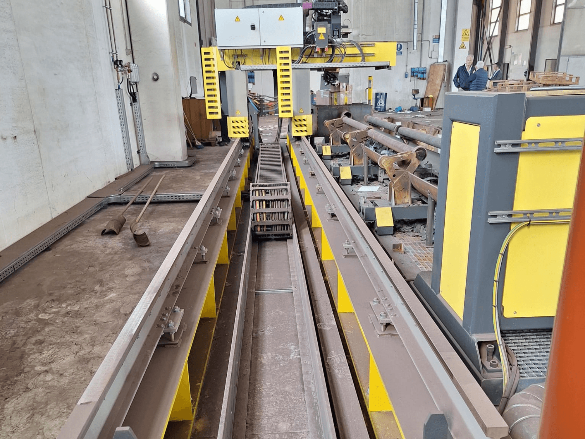 ESAB SUPRAREX 3100 SXE HD 1000 vamzdžių pjovimo staklės iš priekio, kuriose matyti bėgiai, pjovimo galvutė ir geltonos spalvos saugos elementai.