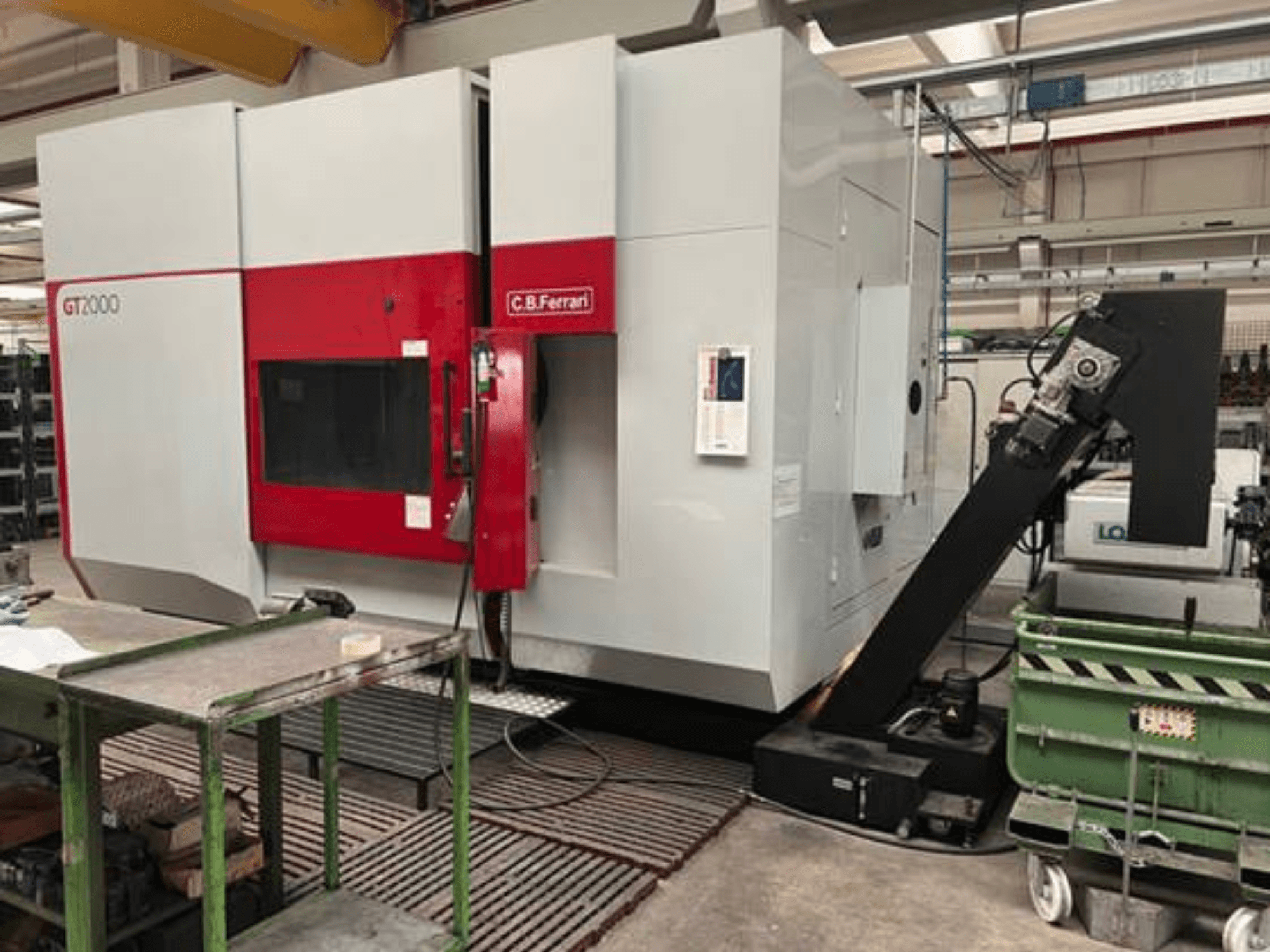 C.B. Ferrari GT2000 frezavimo staklės iš priekio su roboto ranka ir pramonine darbo vieta su žaliu vežimėliu.