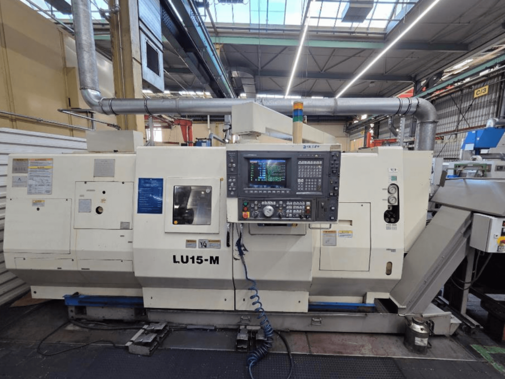 Okuma LU15 M-2SC 1000 horizontalios tekinimo staklės, priekinis vaizdas, kuriame matomas valdymo skydelis ir staklių funkcijos dirbtuvėse.