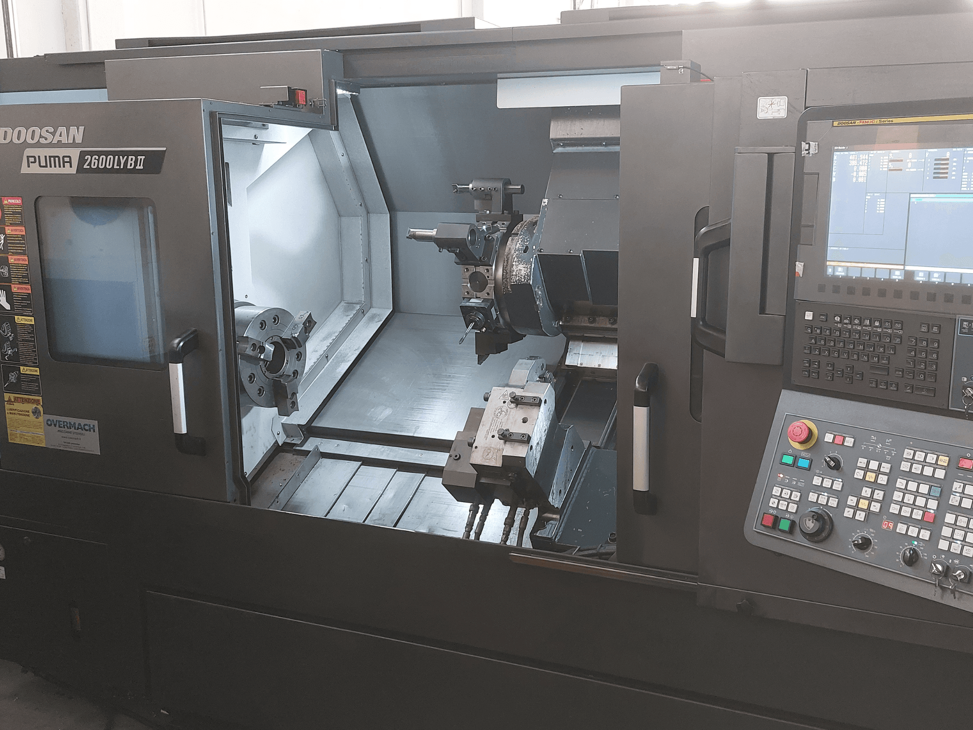 DOOSAN Puma 2600 LYB II horizontaliojo tekinimo staklių priekinis vaizdas, matomas vidus su griebtuvu, įrankių laikikliu ir valdymo skydeliu.