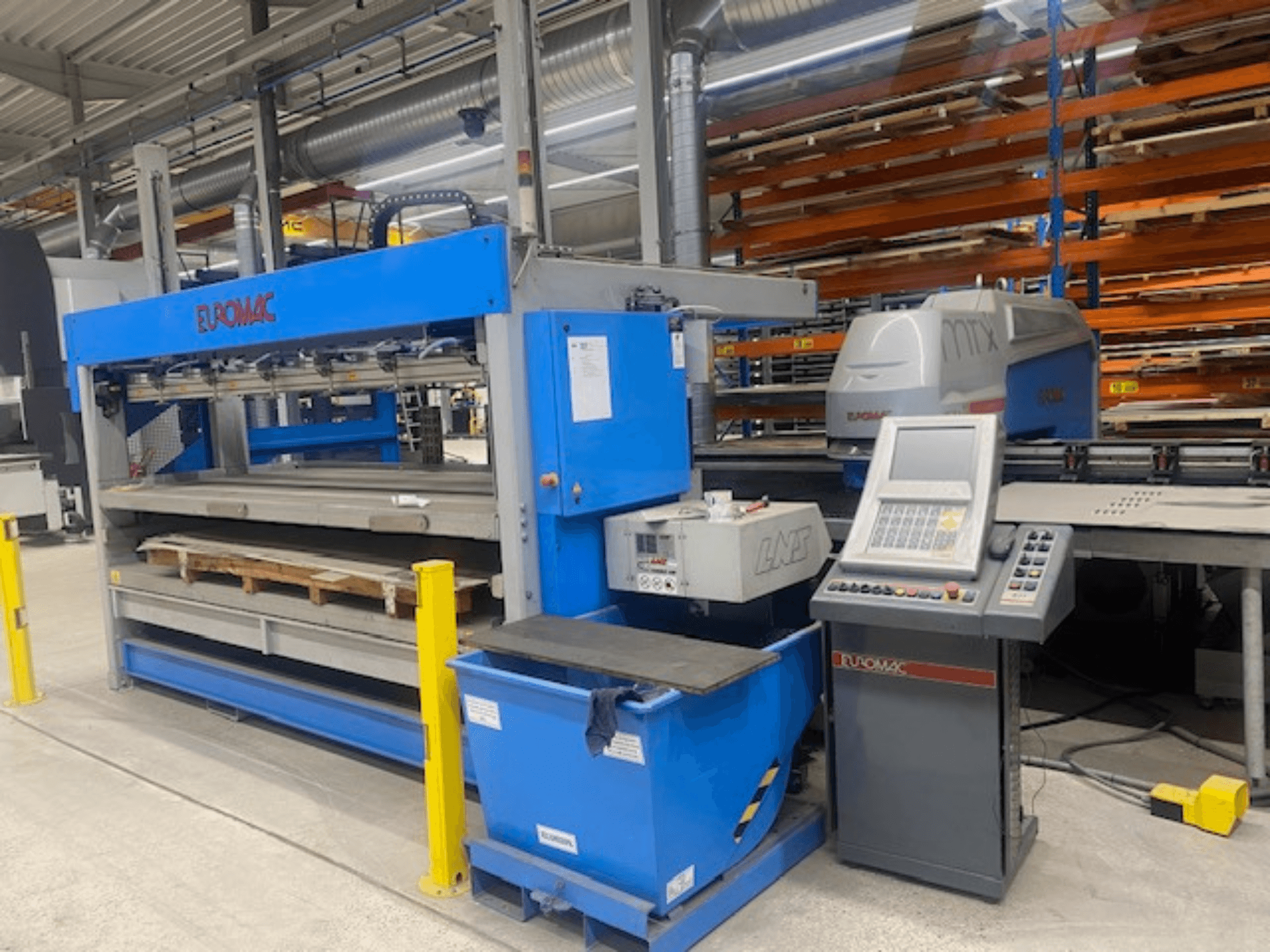 CNC štampavimo staklės „Euromac MTX FLEX 12“, vaizdas iš priekio, kuriame matomas valdymo pultas, padėklai ir saugos įranga.
