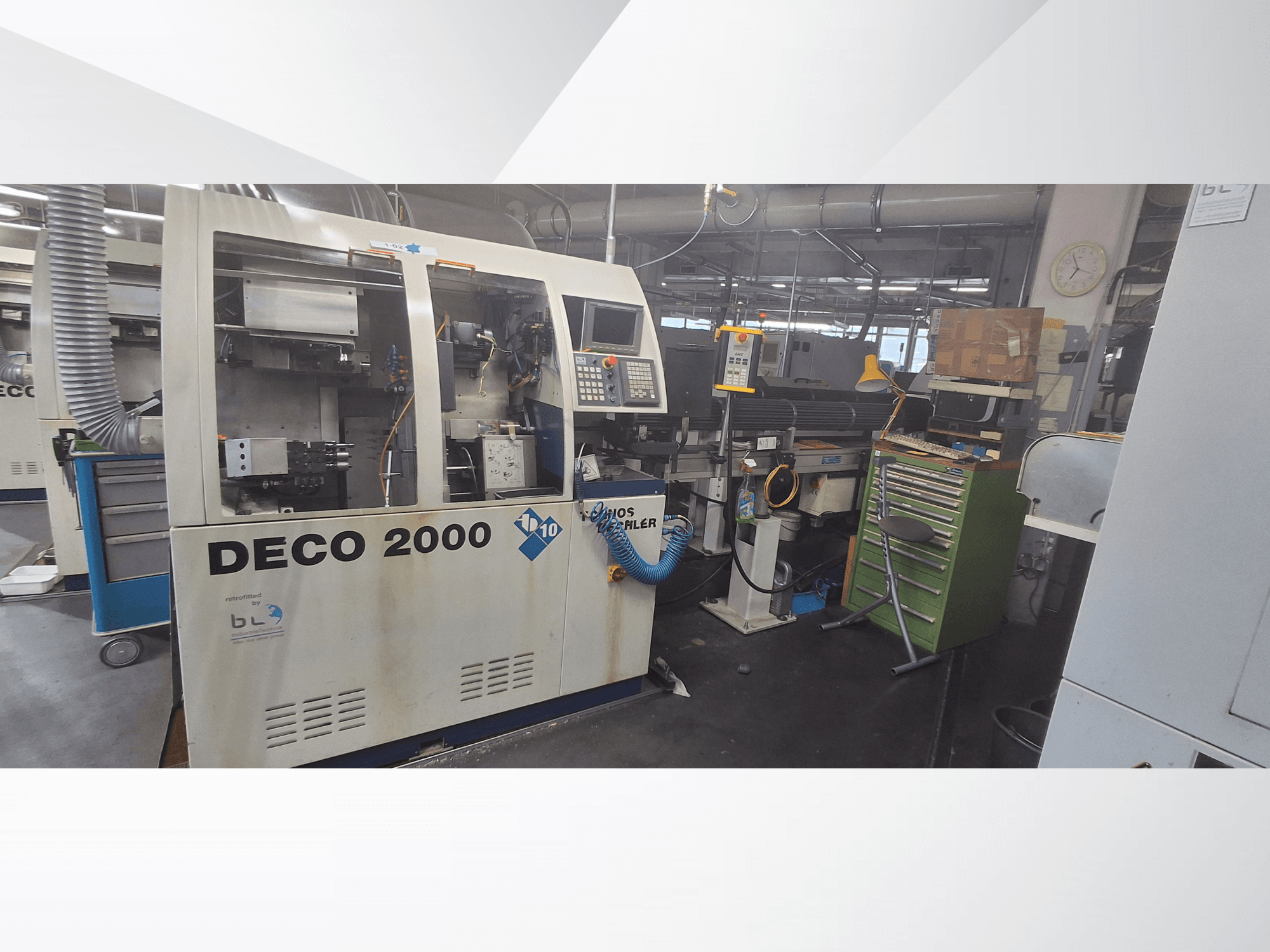 Šveicarų tipo tekinimo staklės „TORNOS DECO 2000-10“, vaizdas iš priekio, kuriame matomas valdymo pultas ir pakrovimo zona dirbtuvėse.